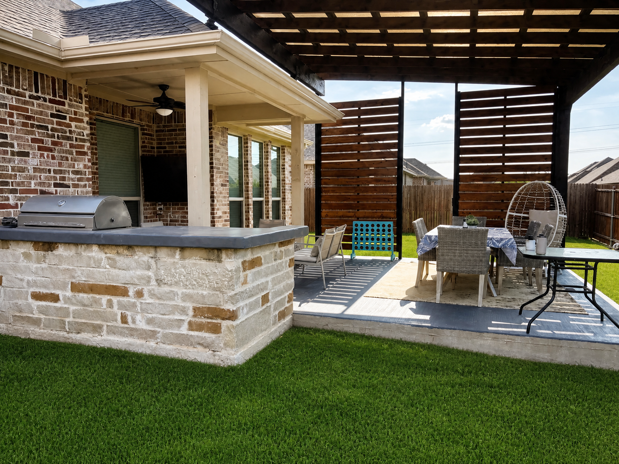Backyard with outdoor kitchen and pergola