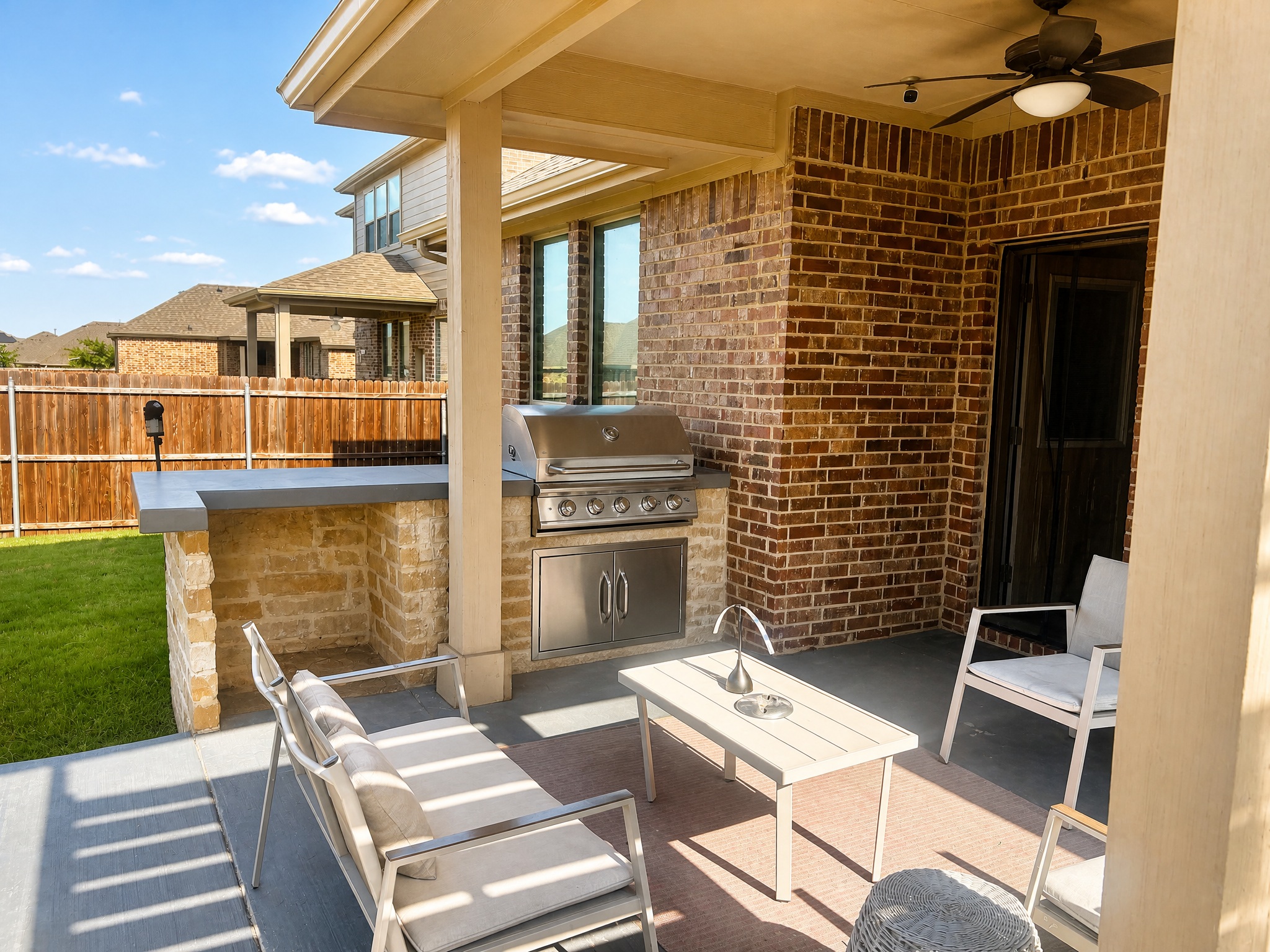 Covered patio with outdoor kitchen and grill