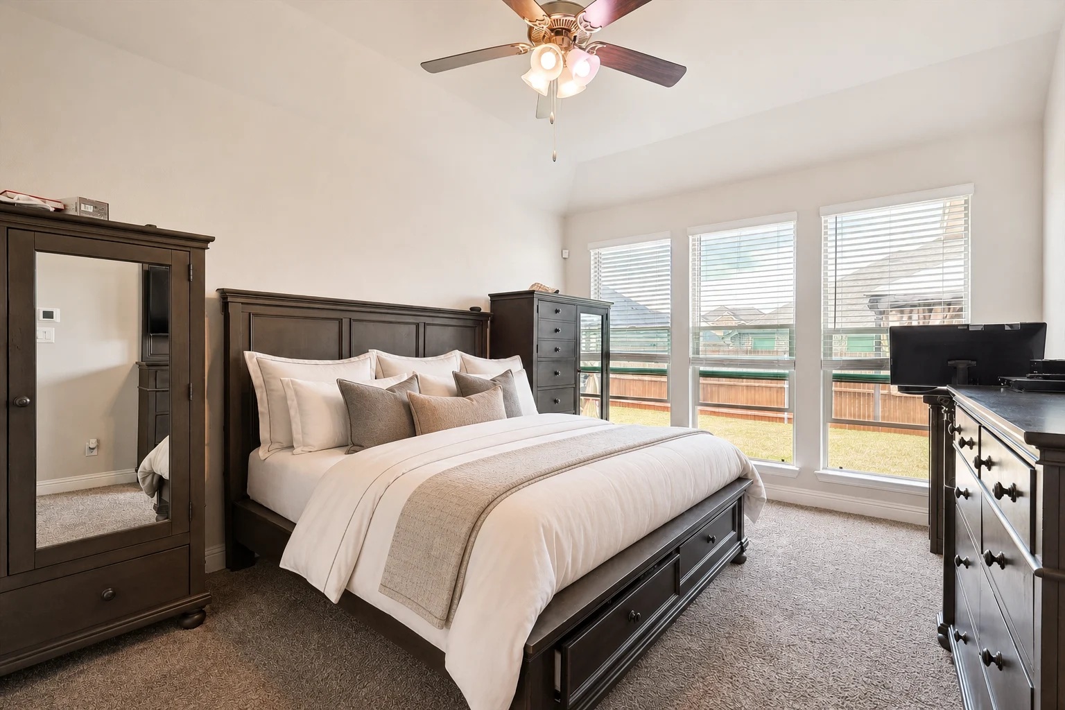 Primary bedroom with vaulted ceiling